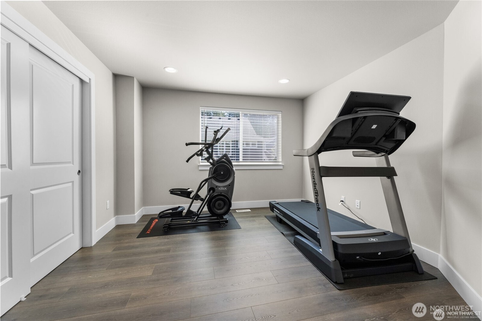 7780 53rd Place Gig Harbor, WA 98335 - Photo 22 of 39 a room with gym equipment and wooden floor