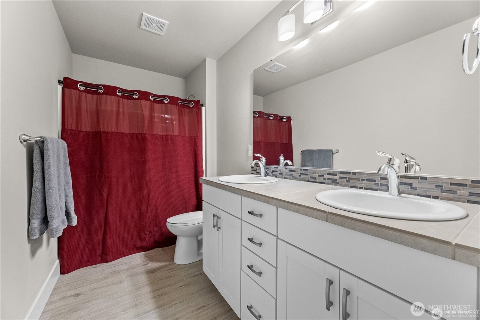 7780 53rd Place Gig Harbor, WA 98335 - Photo 25 of 39 a bathroom with a double vanity sink toilet and shower