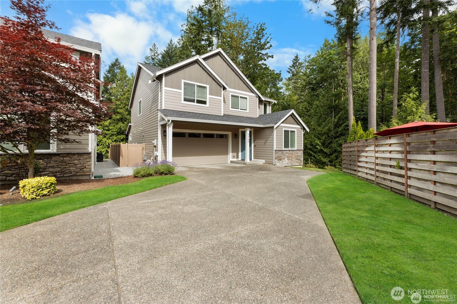 7780 53rd Place Gig Harbor, WA 98335 - Photo 27 of 39 a front view of a house with a garden and plants