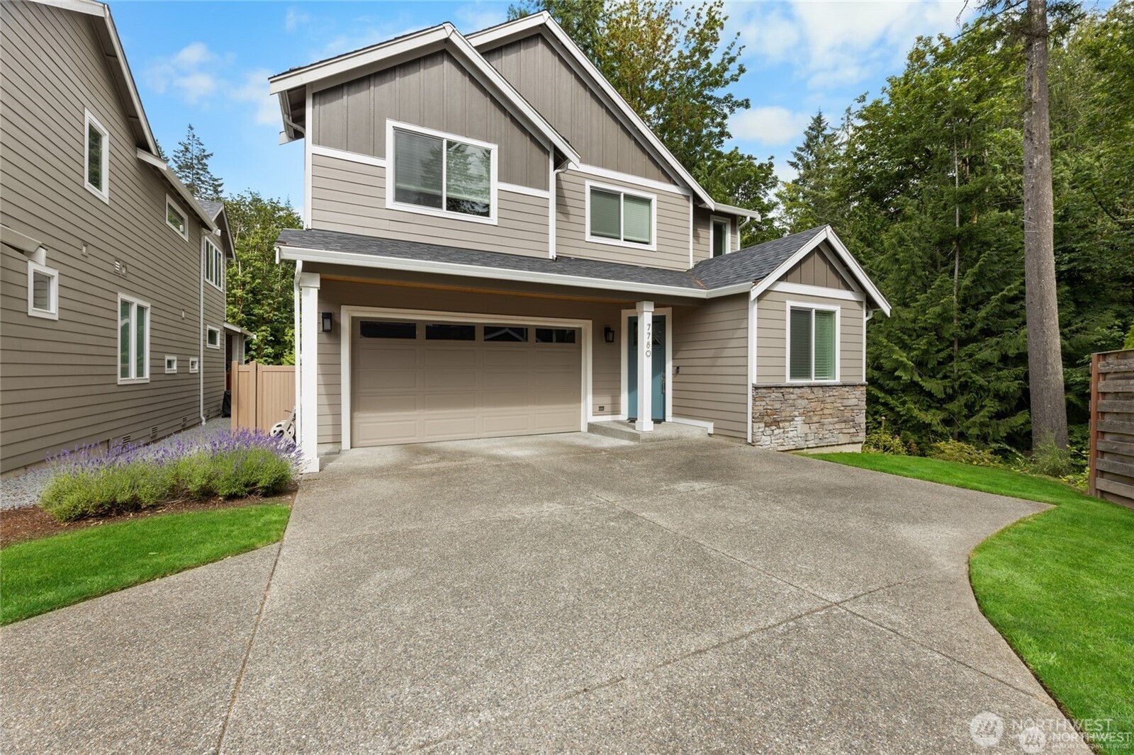 7780 53rd Place Gig Harbor, WA 98335 - Photo 38 of 39 a front view of a house with a garden and trees