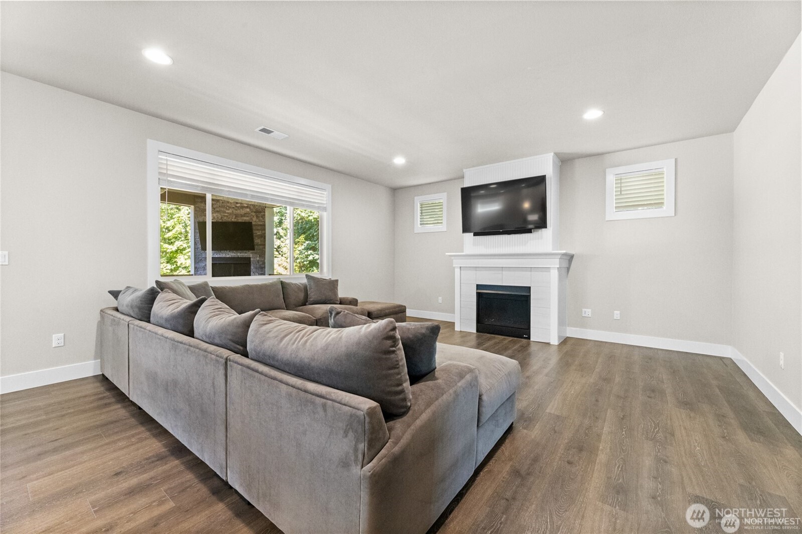 7780 53rd Place Gig Harbor, WA 98335 - Photo 6 of 39 a living room with furniture a fireplace and a flat screen tv