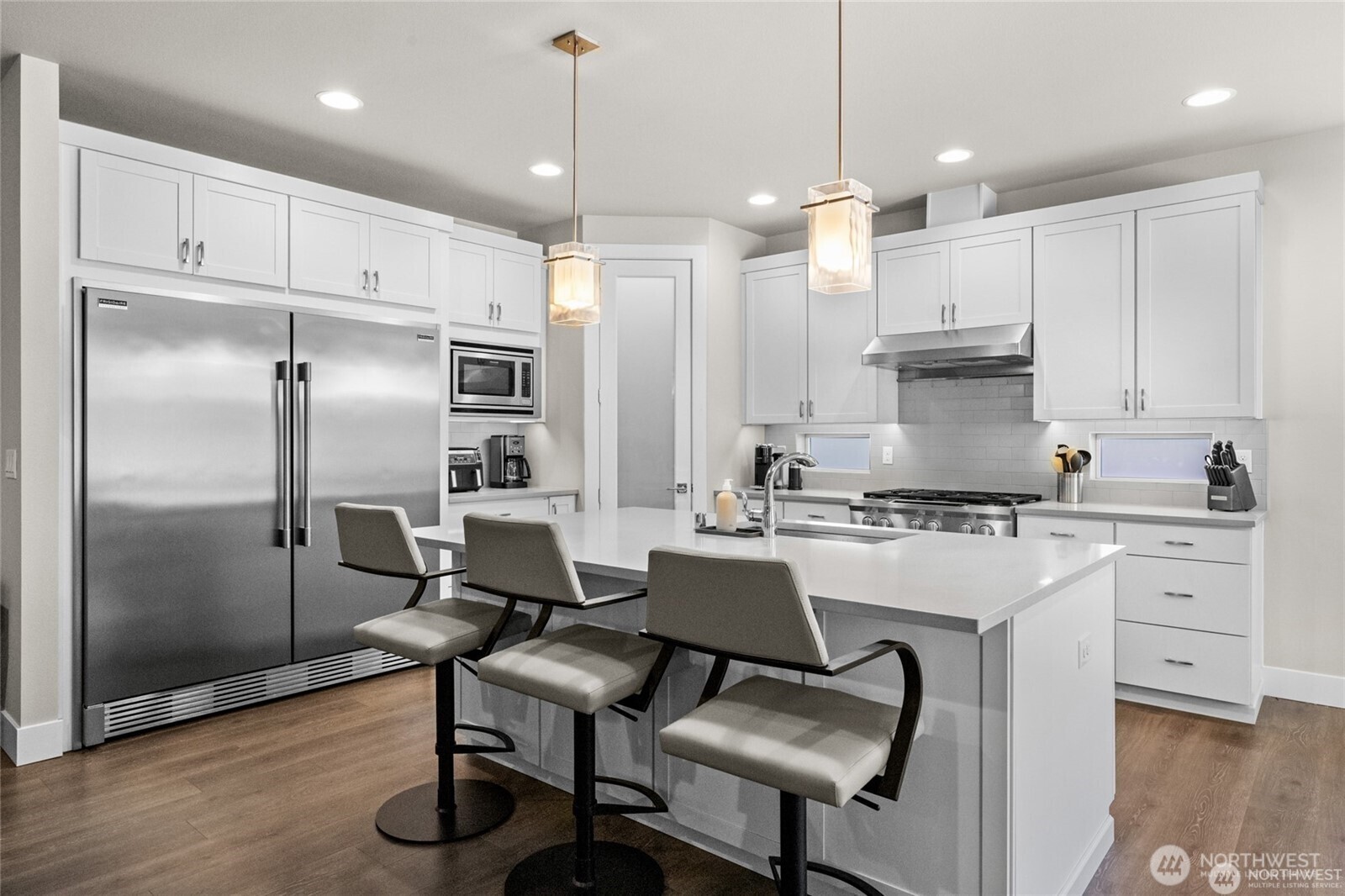 7780 53rd Place Gig Harbor, WA 98335 - Photo 8 of 39 a kitchen with refrigerator cabinets and chairs