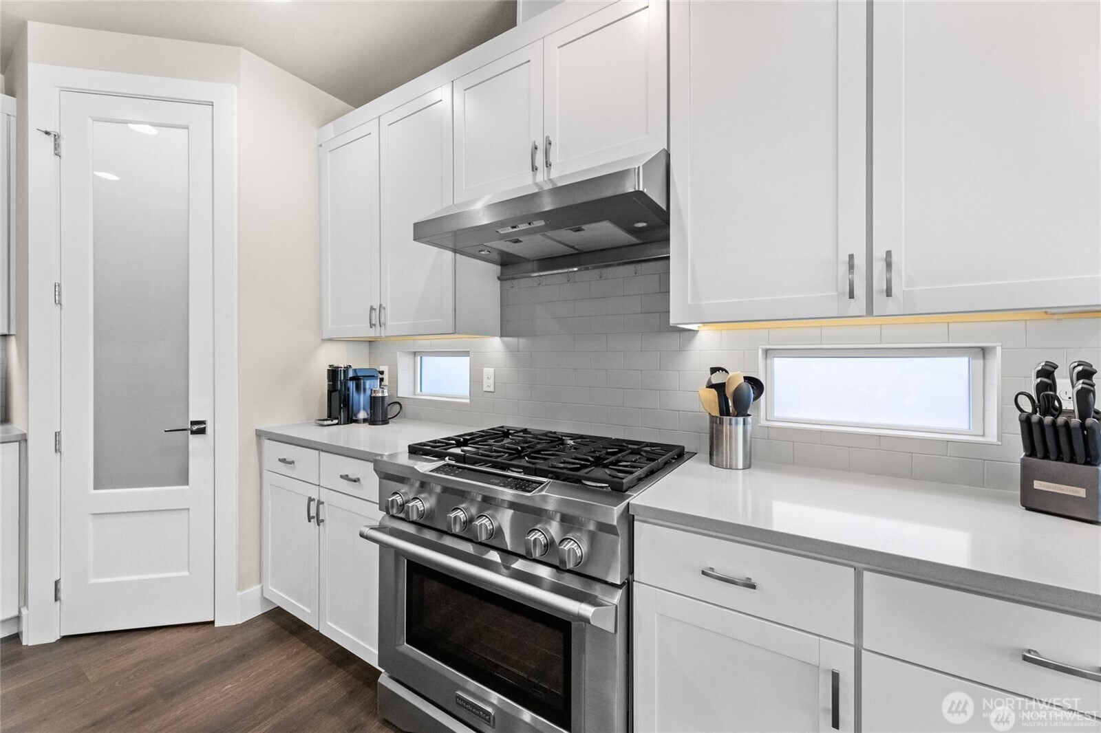 7780 53rd Place Gig Harbor, WA 98335 - Photo 10 of 39 a kitchen with stainless steel appliances a stove and white cabinets