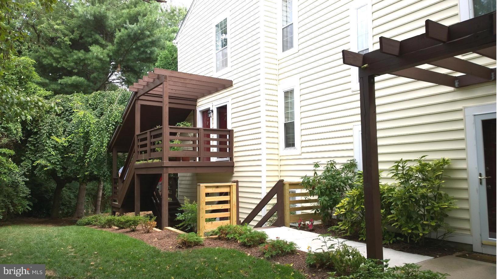 9927 Oakton Terrace Road, Unit 9927 Oakton, VA 22124 - Photo 2 of 19 a front view of a house with a yard