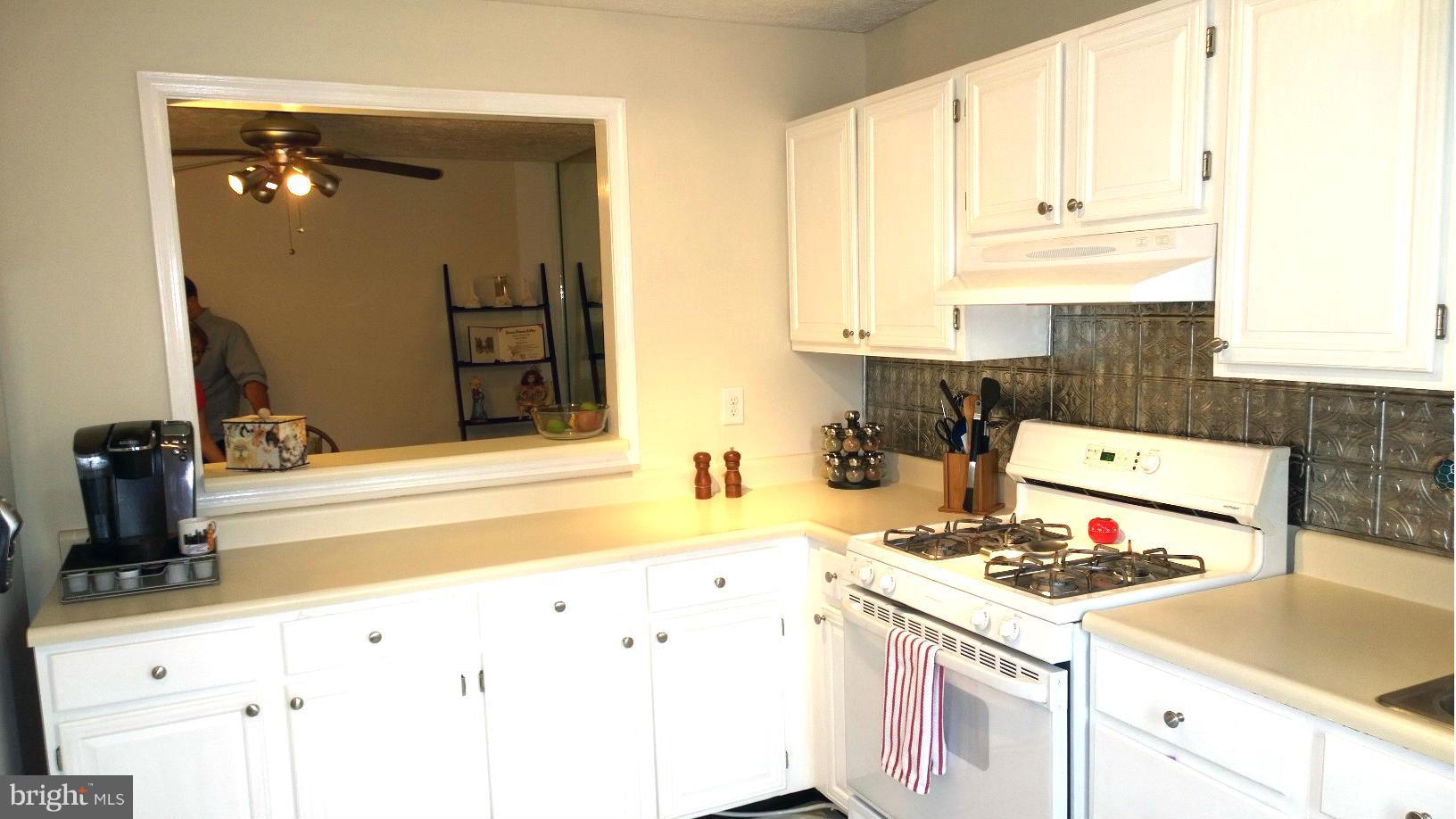9927 Oakton Terrace Road, Unit 9927 Oakton, VA 22124 - Photo 7 of 19 a kitchen with granite countertop a stove and a sink