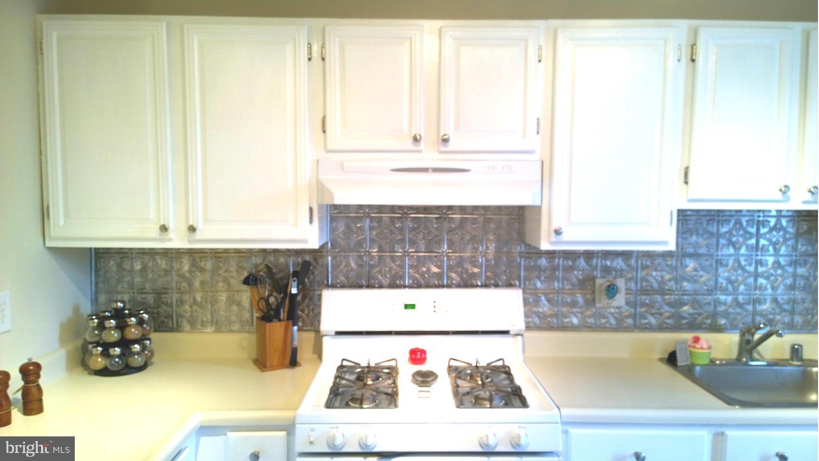 9927 Oakton Terrace Road, Unit 9927 Oakton, VA 22124 - Photo 8 of 19 a kitchen with a sink and cabinets