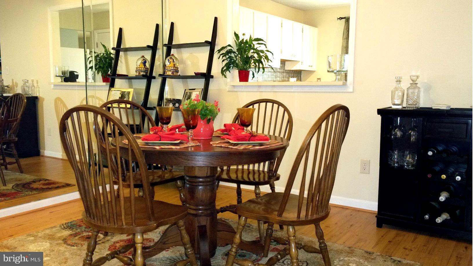 9927 Oakton Terrace Road, Unit 9927 Oakton, VA 22124 - Photo 9 of 19 a view of a dining room with furniture one side kitchen view and large windows