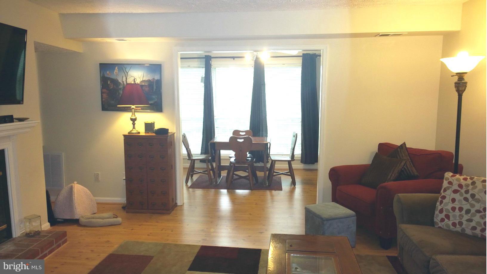 9927 Oakton Terrace Road, Unit 9927 Oakton, VA 22124 - Photo 10 of 19 a living room with couches a coffee table and a flat screen tv
