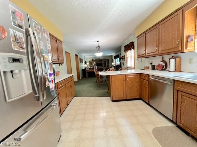 1349 Deer Hill Road Dennison, OH 44621 - Photo 12 of 36 Kitchen with kitchen peninsula, light carpet, stainless steel appliances, and decorative light fixtures