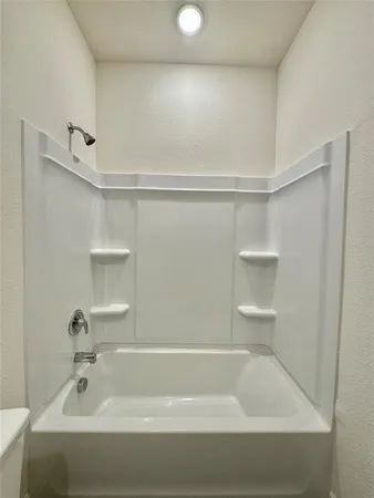 a bathroom with a toilet a sink and wooden floor