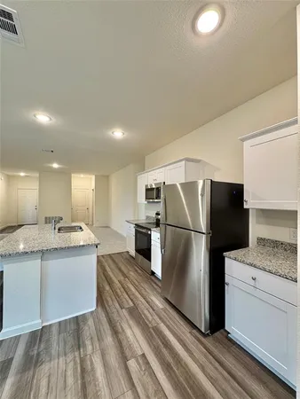 a kitchen with a sink stainless steel appliances and cabinets