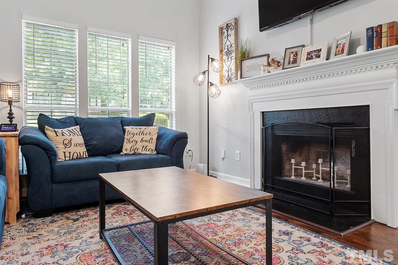 4433 Labrador Drive Raleigh, NC 27616 - Photo 11 of 30 a living room with furniture a window and a fireplace
