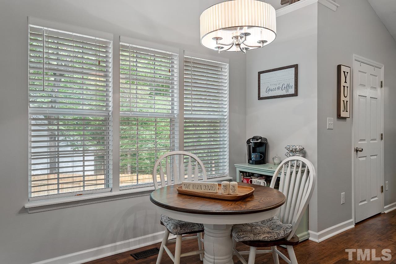 4433 Labrador Drive Raleigh, NC 27616 - Photo 13 of 30 a view of a dining room with furniture and chandelier