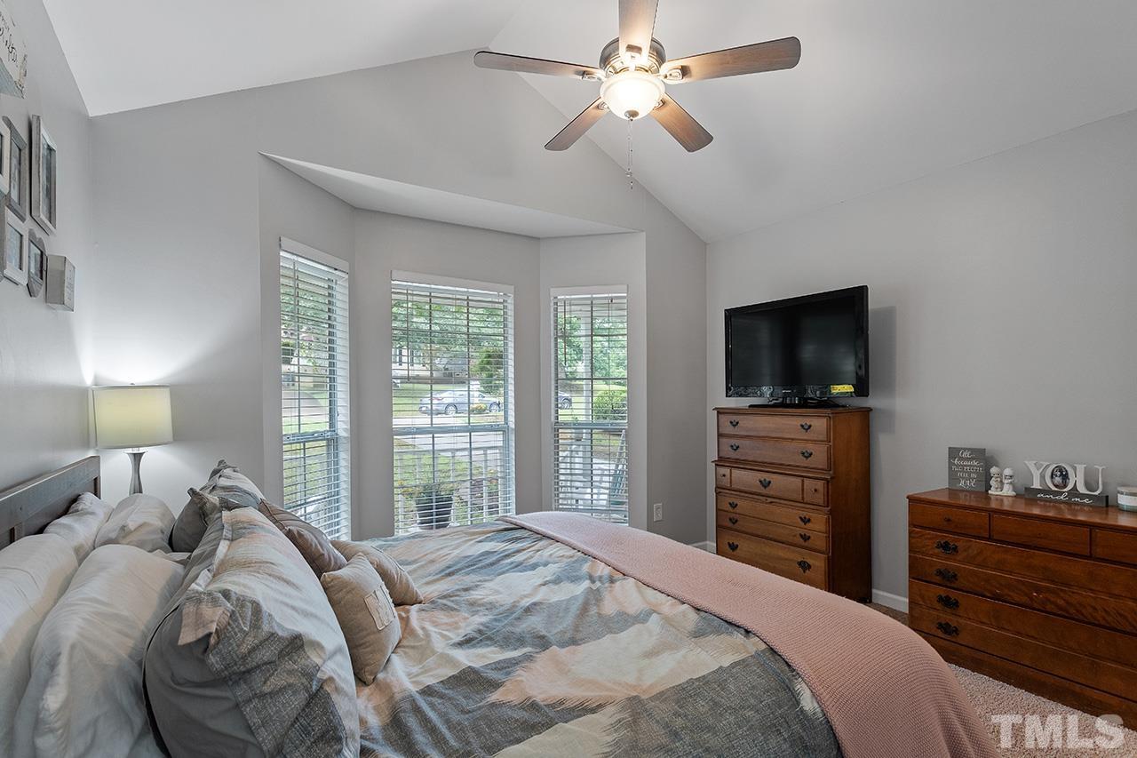 4433 Labrador Drive Raleigh, NC 27616 - Photo 17 of 30 a bedroom with a bed and a flat screen tv