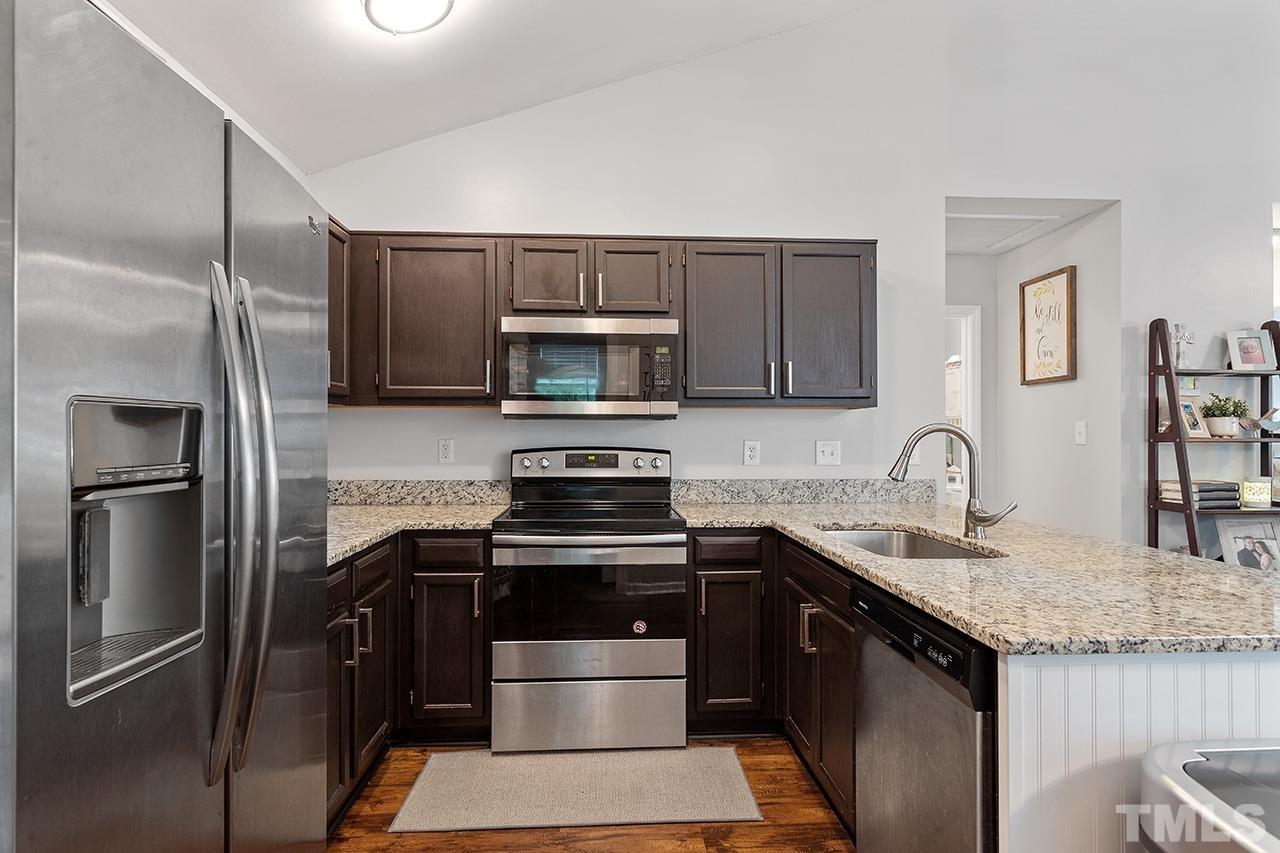 4433 Labrador Drive Raleigh, NC 27616 - Photo 6 of 30 a kitchen with stainless steel appliances granite countertop a refrigerator stove and sink