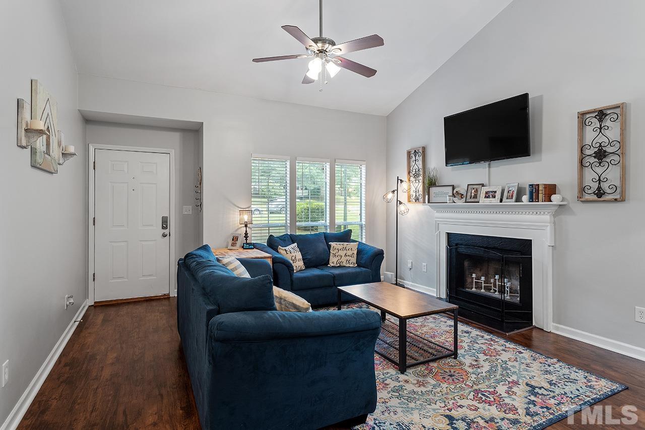 4433 Labrador Drive Raleigh, NC 27616 - Photo 10 of 30 a living room with furniture a flat screen tv and a fireplace