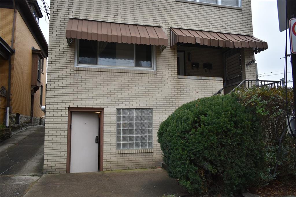 a backyard of a house with wooden floor and garage