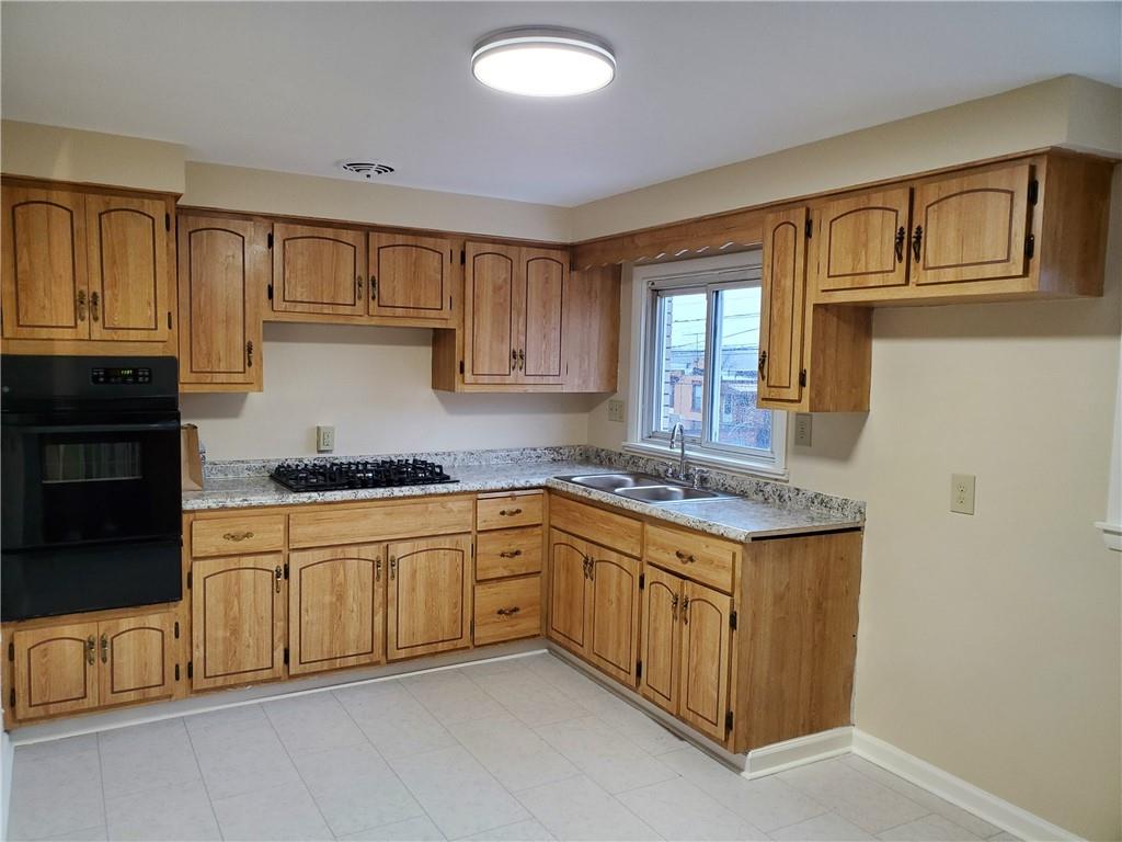 1539 Beechview Avenue Beechview, PA 15216 - Photo 4 of 22 a kitchen with granite countertop cabinets stainless steel appliances a sink and a window