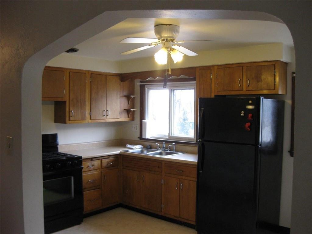 1539 Beechview Avenue Beechview, PA 15216 - Photo 5 of 22 a kitchen with a refrigerator a stove a sink and a window