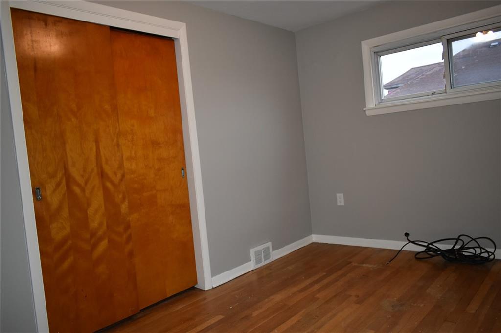 1539 Beechview Avenue Beechview, PA 15216 - Photo 9 of 22 an empty room with wooden floor and windows