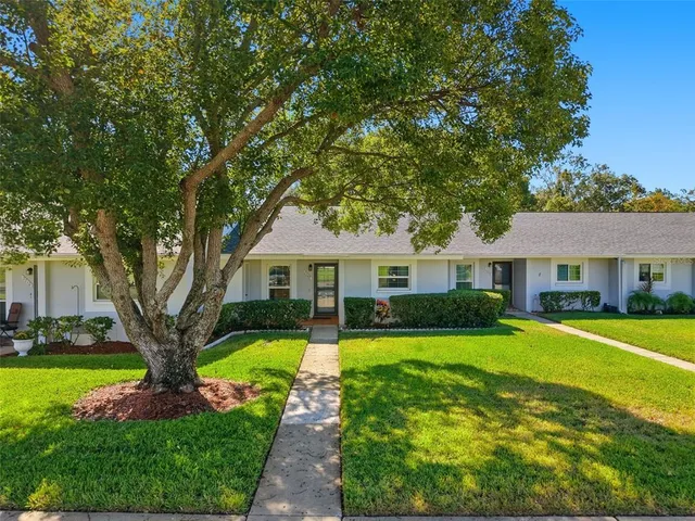 a front view of a house with yard and green space
