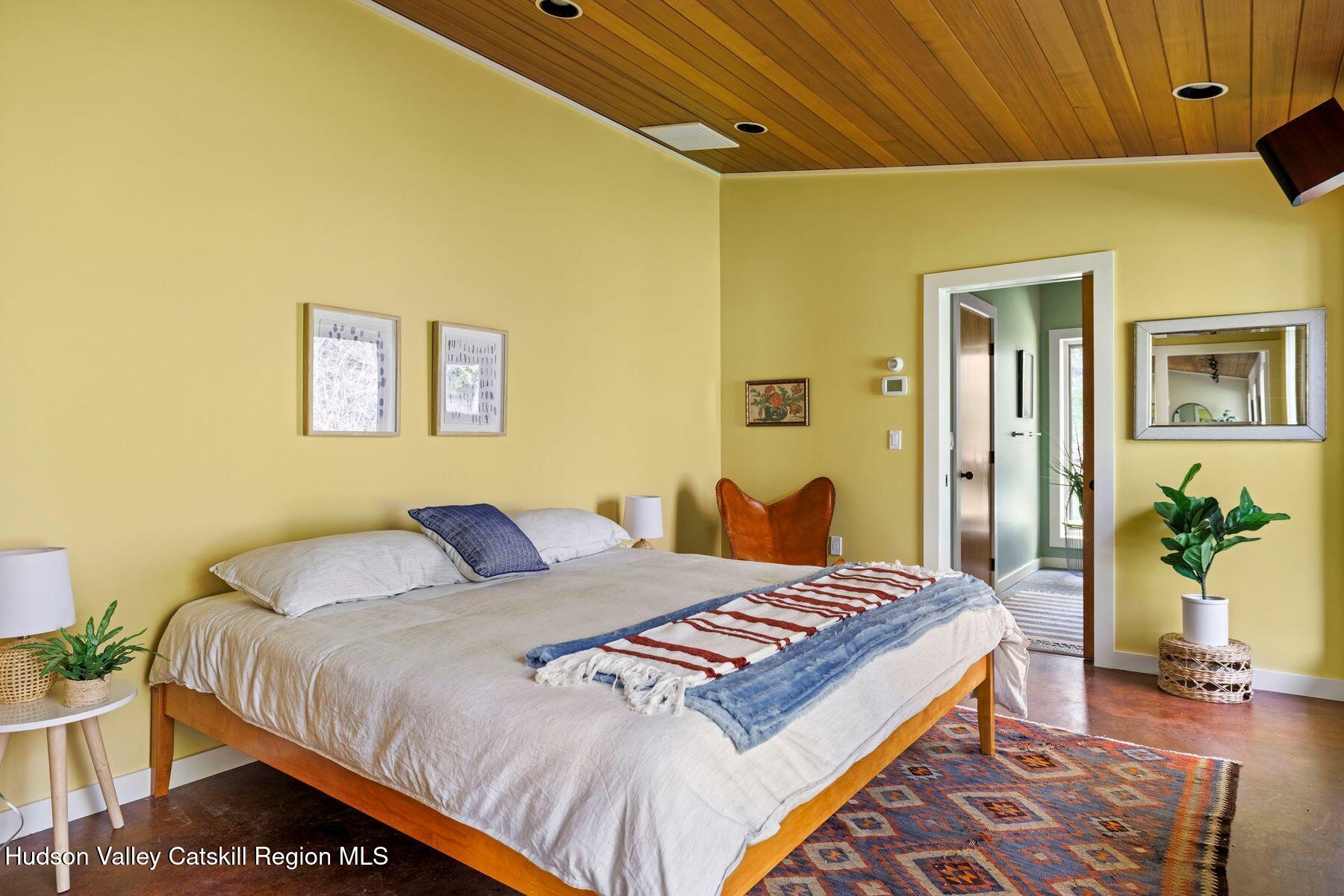 41 Shultis Farm Road Bearsville, NY 12409 - Photo 27 of 47 a bedroom with a bed and wooden floor