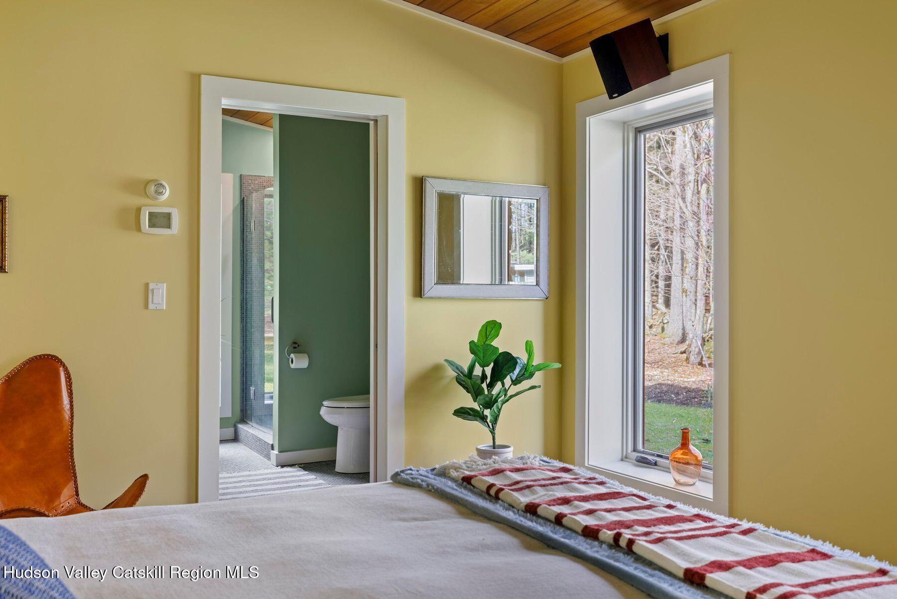 41 Shultis Farm Road Bearsville, NY 12409 - Photo 28 of 47 a bedroom with a bed and a dresser next to a window