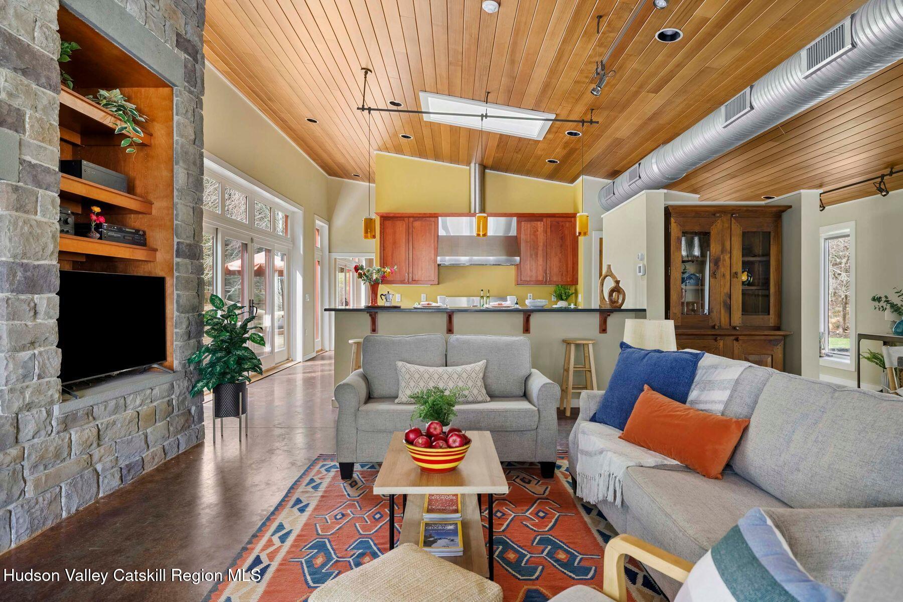 41 Shultis Farm Road Bearsville, NY 12409 - Photo 5 of 47 a living room with patio furniture and a flat screen tv