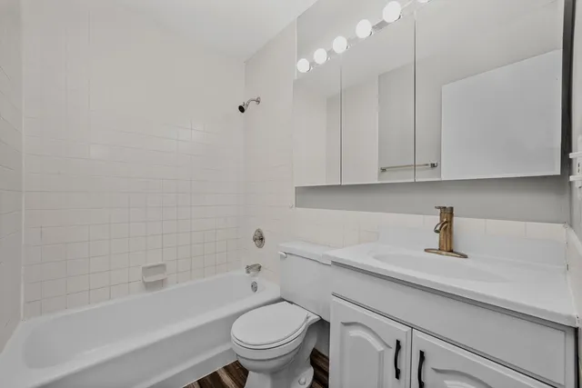 a bathroom with a sink a toilet and bathtub