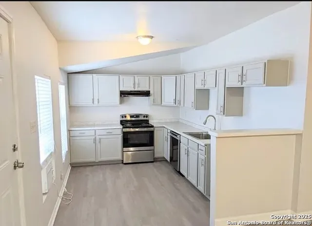 a kitchen with stainless steel appliances a refrigerator stove and sink