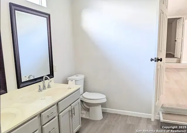 a bathroom with a sink a toilet and a mirror