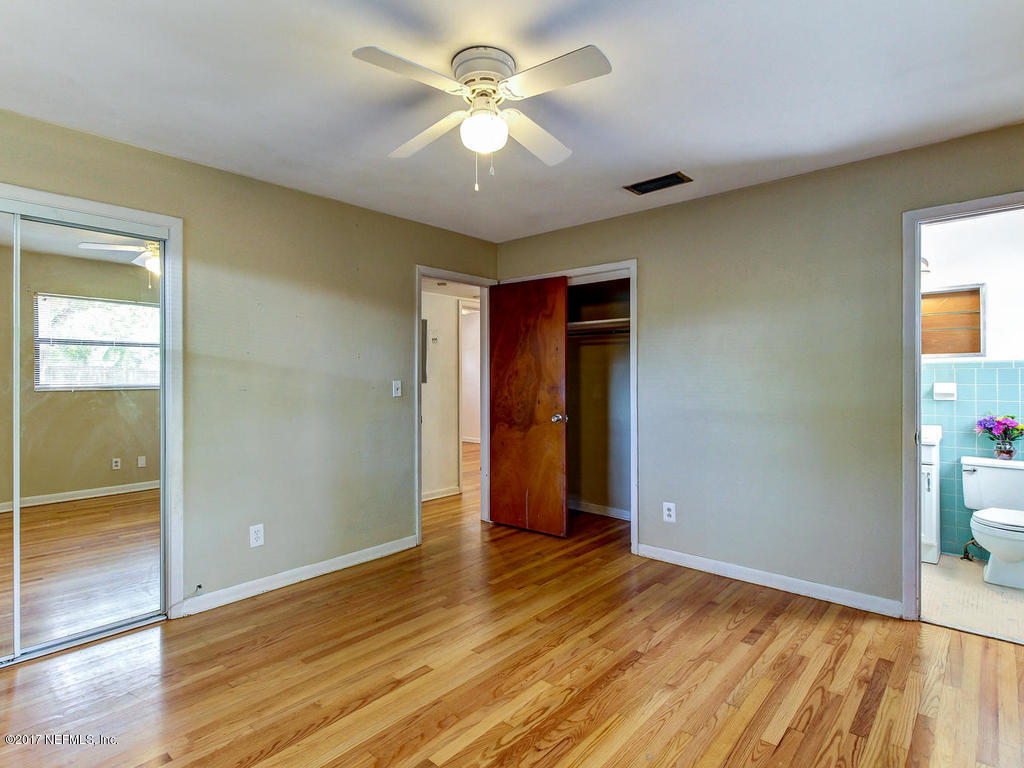3755 Rogero Road Jacksonville, FL 32277 - Photo 18 of 32 wooden floor in an empty room with a window
