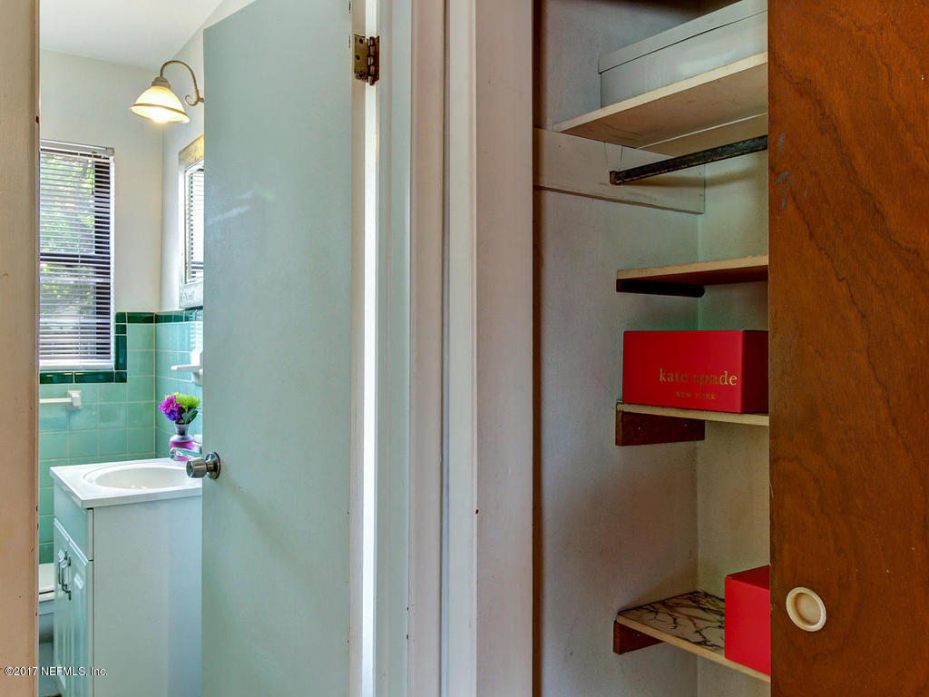 3755 Rogero Road Jacksonville, FL 32277 - Photo 24 of 32 a bathroom with a sink mirror and vanity
