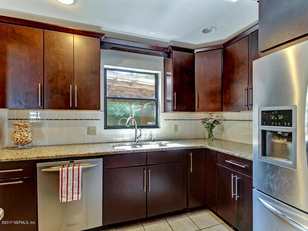3755 Rogero Road Jacksonville, FL 32277 - Photo 8 of 32 a kitchen with stainless steel appliances granite countertop a sink stove and refrigerator