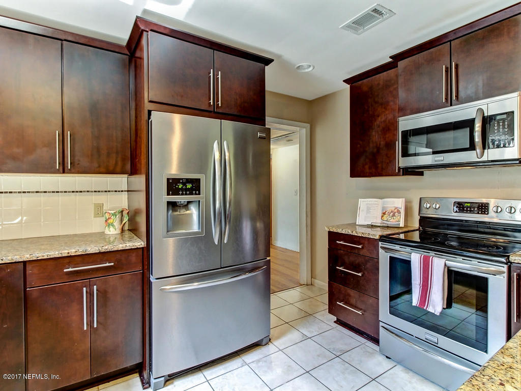 3755 Rogero Road Jacksonville, FL 32277 - Photo 10 of 32 a metallic refrigerator freezer sitting in a kitchen