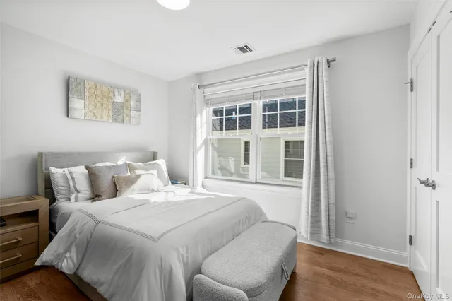 a bedroom with a large bed and a window