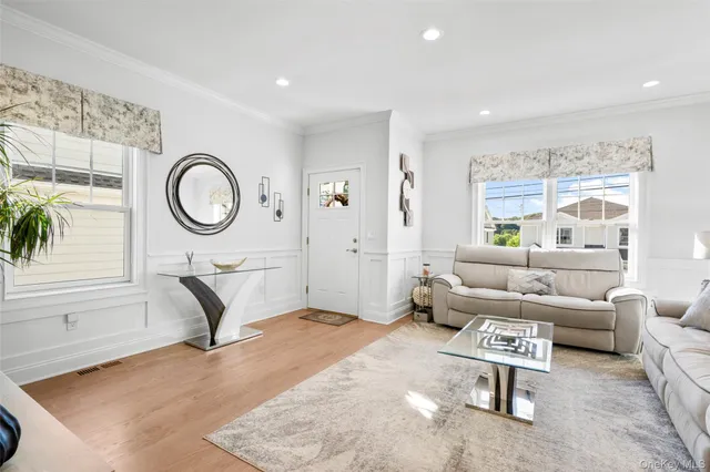 a living room with furniture a clock and a window