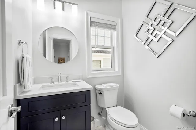 a bathroom with a toilet sink and mirror