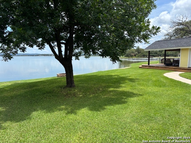 a view of backyard with swimming pool and green space