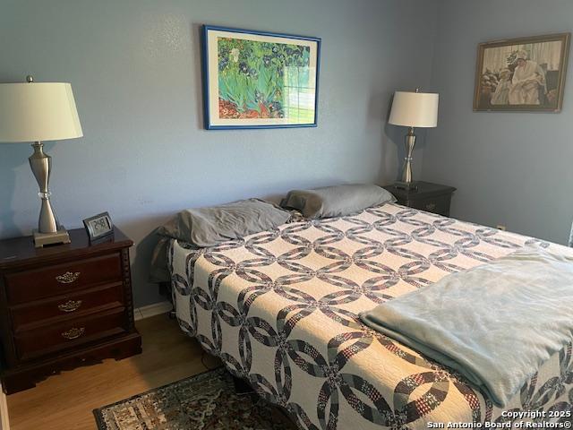400 North Chaparral Burnet, TX 78611 - Photo 12 of 24 a bedroom with a bed and a lamp on dresser