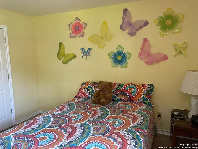 a bedroom with a bed and a painting on the wall