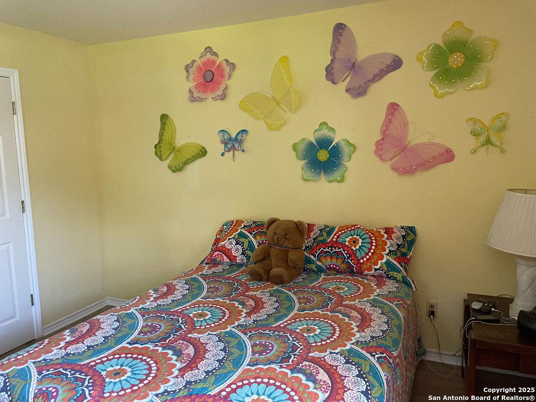 400 North Chaparral Burnet, TX 78611 - Photo 16 of 24 a bedroom with a bed and a painting on the wall