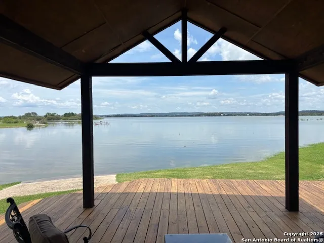 a view of swimming pool with seating space and wooden floor