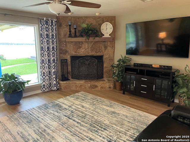 400 North Chaparral Burnet, TX 78611 - Photo 5 of 24 a living room with furniture a flat screen tv and a fireplace