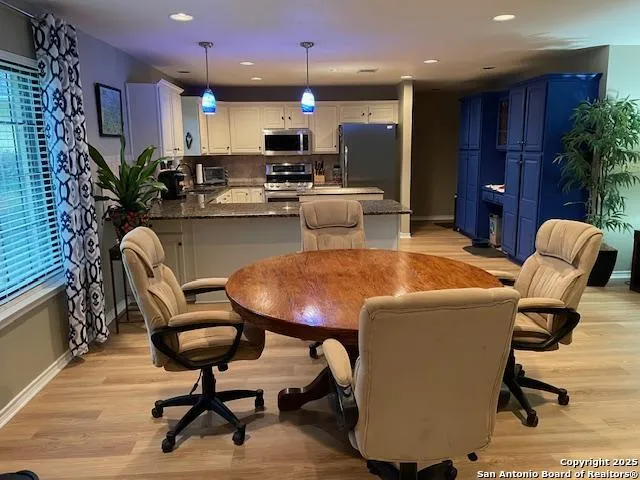 a dining room with furniture and a kitchen