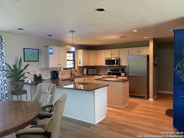 a kitchen with counter space cabinets and appliances