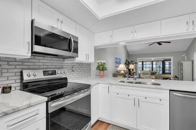 a kitchen with a sink stove and microwave