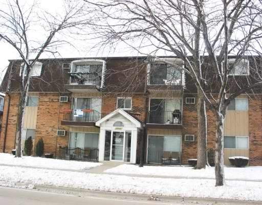 10440 South Ridgeland Avenue, Unit 11 Chicago Ridge, IL 60415 - Photo 1 of 1 a front view of a house with a yard