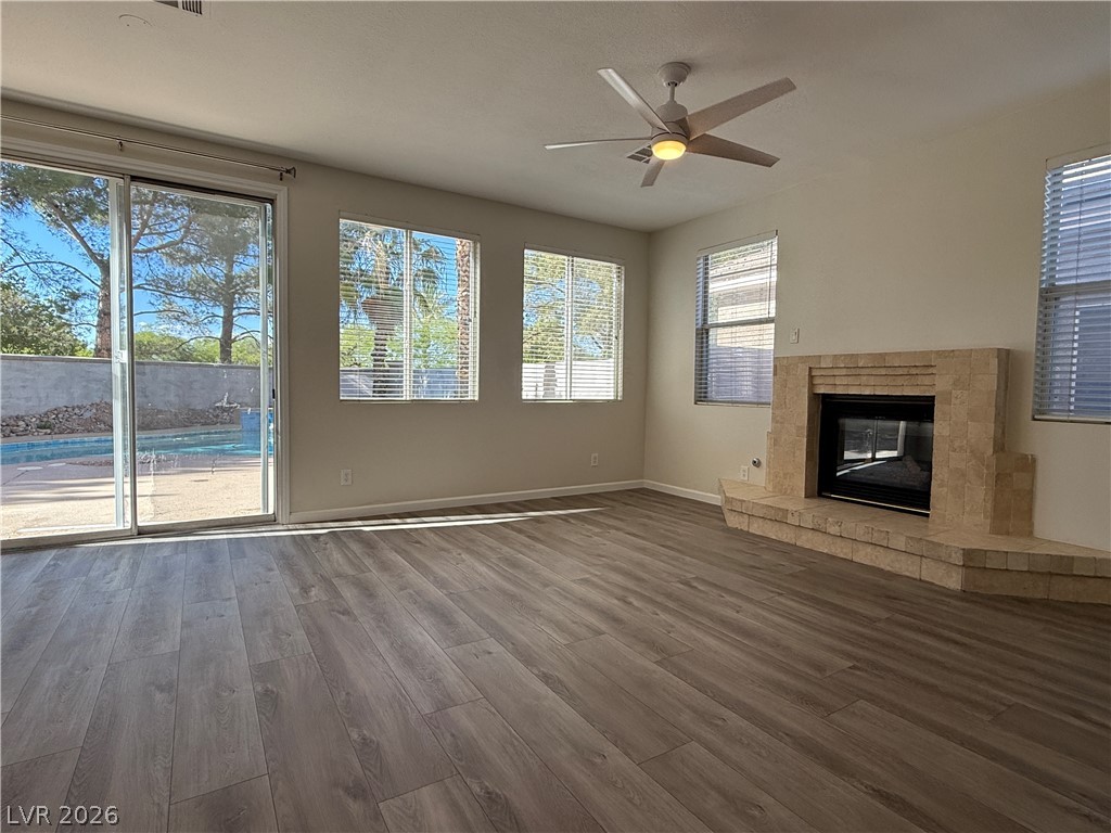 1908 Thunder Ridge Circle Henderson, NV 89012 - Photo 9 of 28 Natural light floods this living space, highlighting the fireplace and the inviting pool view.