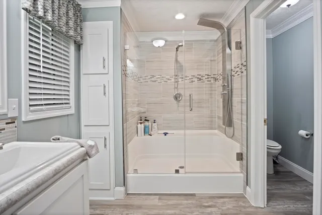 a bathroom with a granite countertop sink and a bathtub